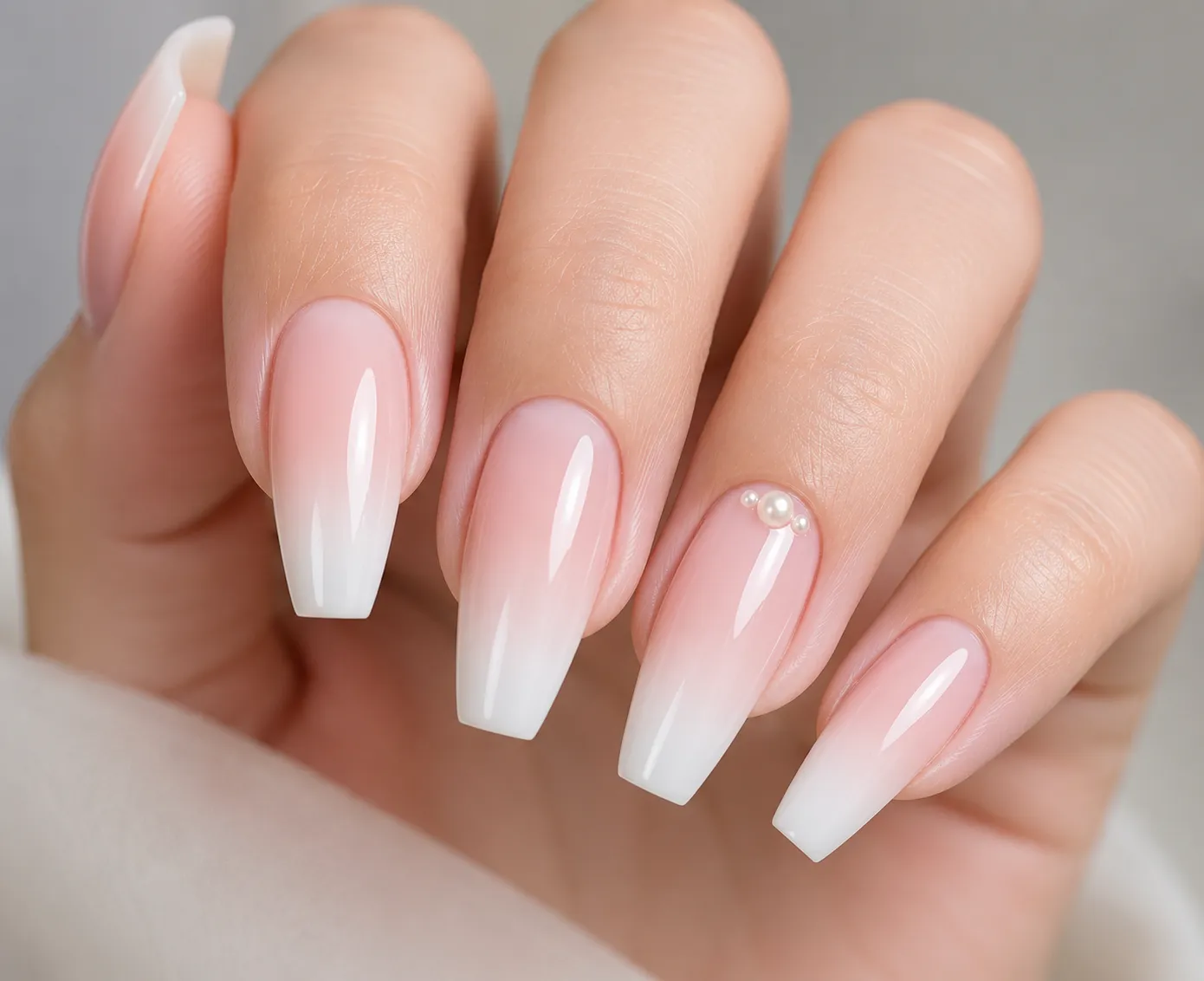 Baby Boomer bridal nails with tiny pearls placed on one accent nail