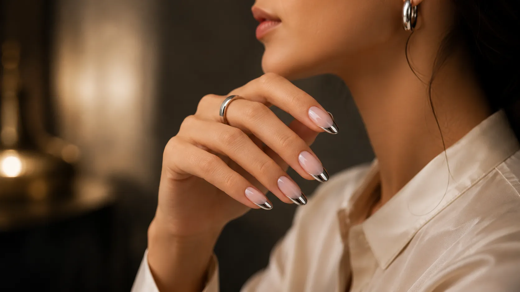 Luxury silver chrome French tip nails on medium squoval nails with a clear mirror finish