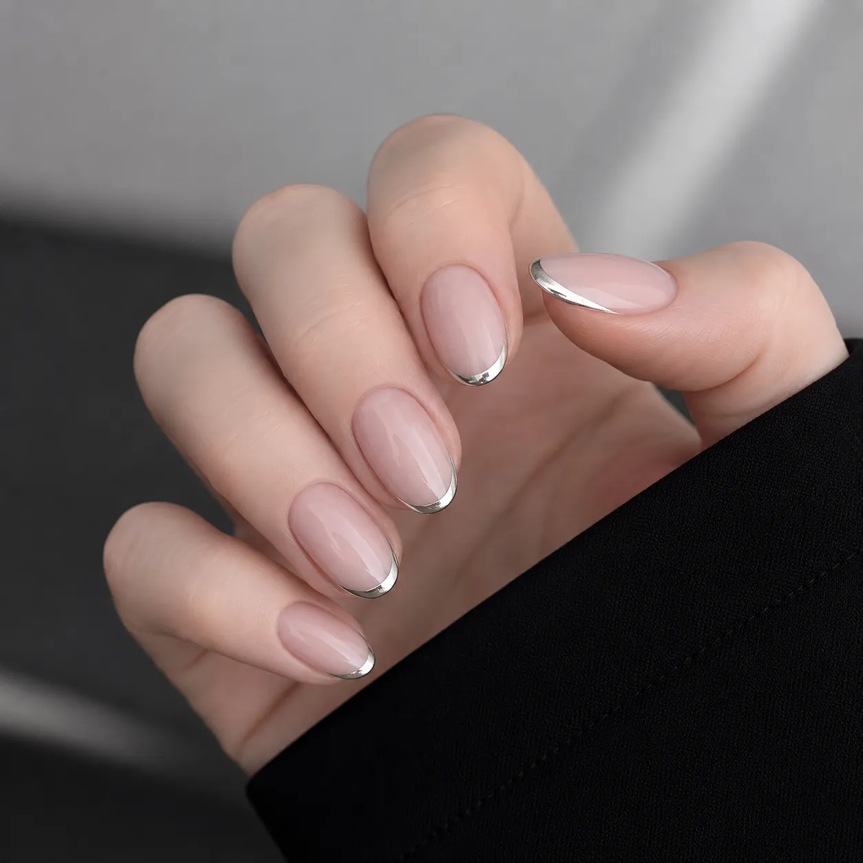 Reflective silver chrome micro French tips on glossy nude nails