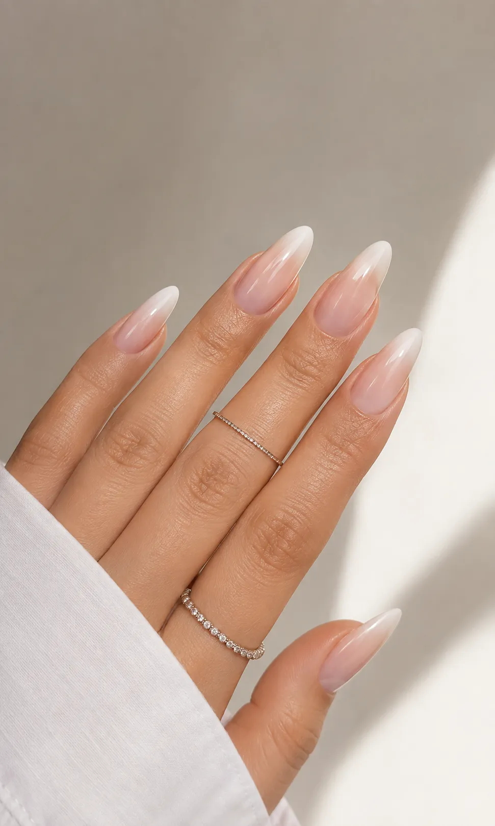 Baby Boomer nails on medium neutral skin with balanced blush beige base