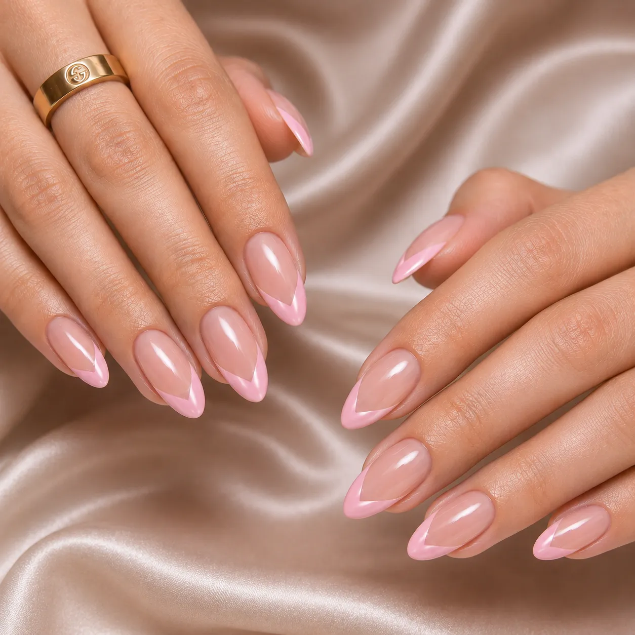 Blush pink V-cut French tip nails with a glossy neutral base