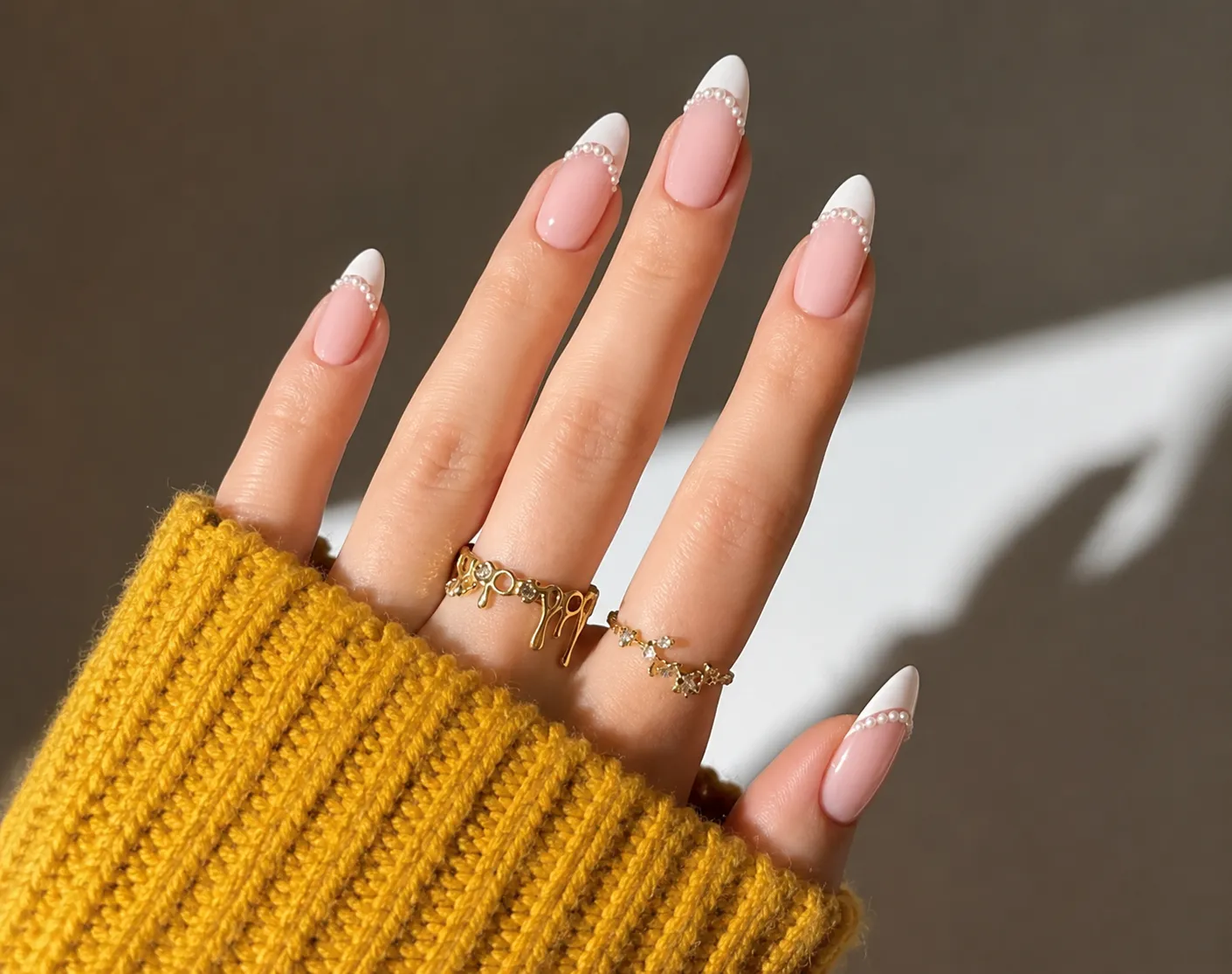 French tip nails with a precise line of micro pearls