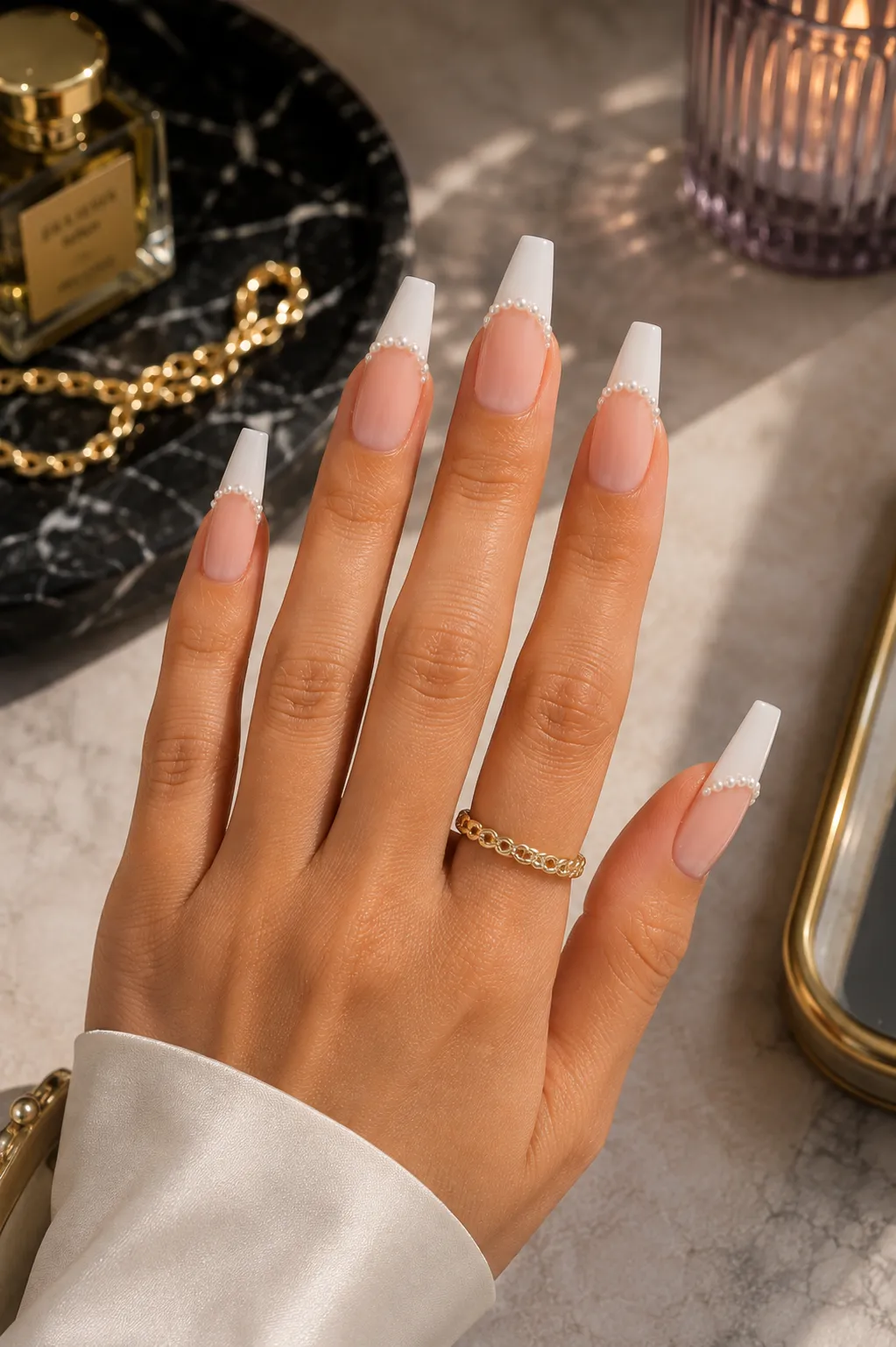 Coffin pearl French tip nails showing a broad flat terminal edge
