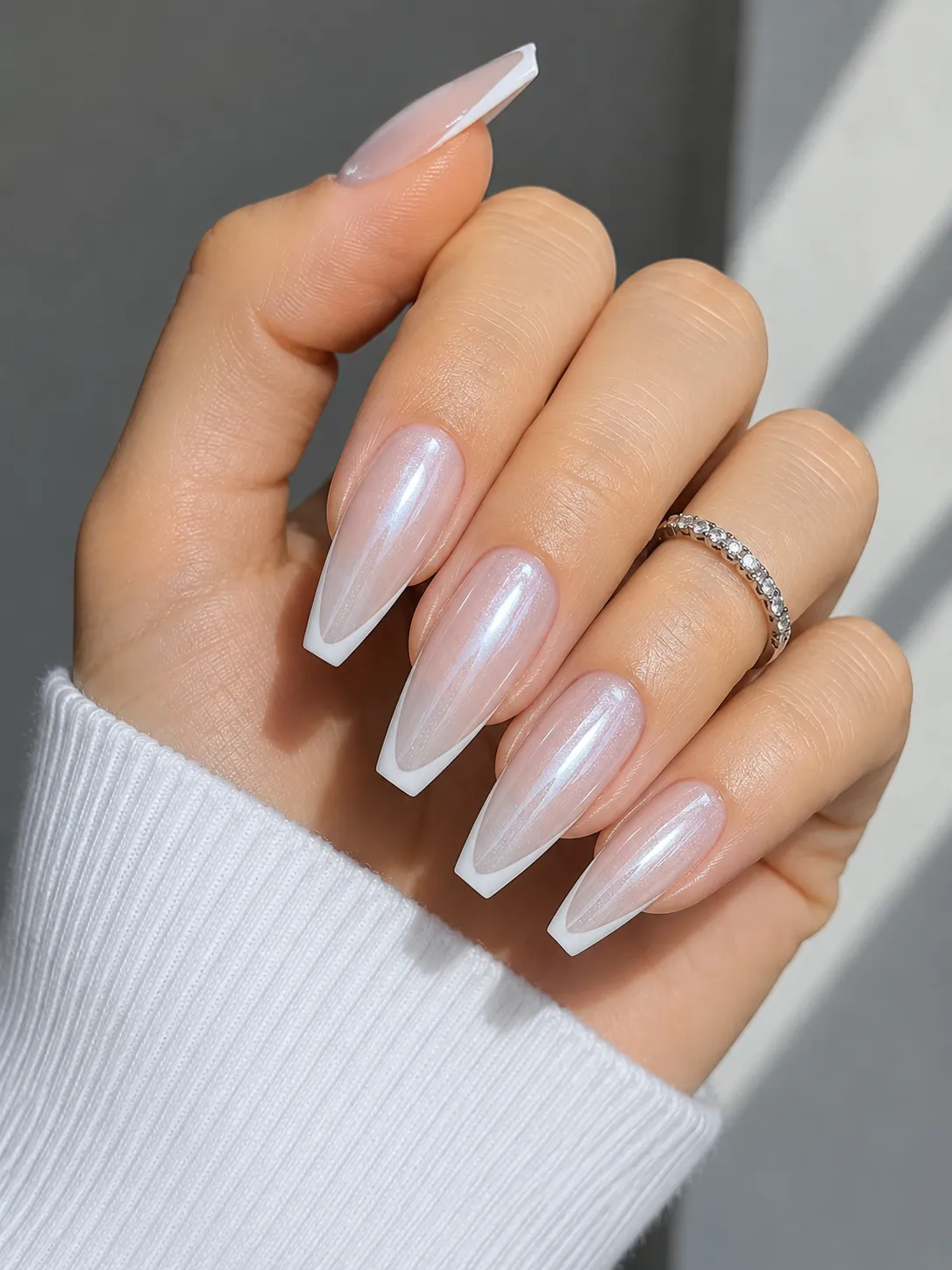Icy milky glazed French tip nails on fair cool-toned skin