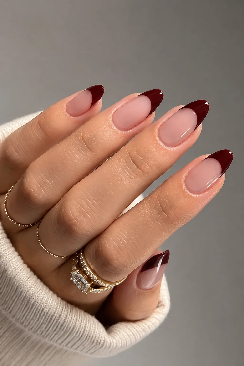 Deep burgundy French tip nails with a muted sophisticated finish