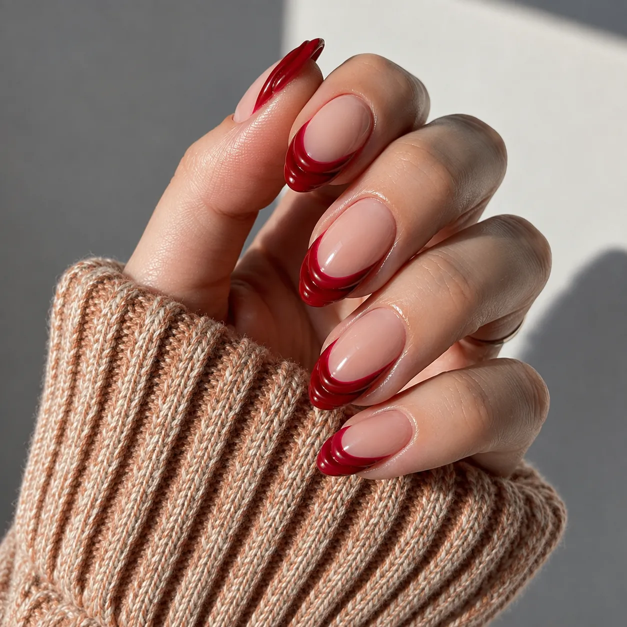 Red French tip showing a raised edge caused by heavy polish layers