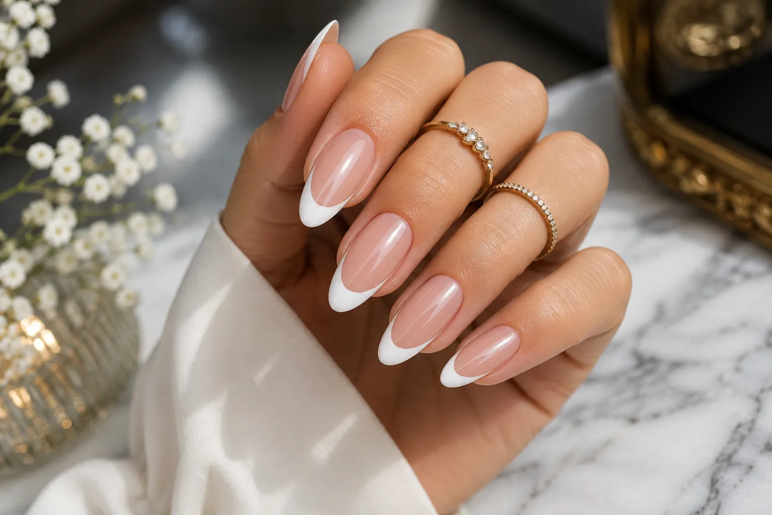 Luxury almond French tip nails with a gradual tapered silhouette and crisp curved white tips
