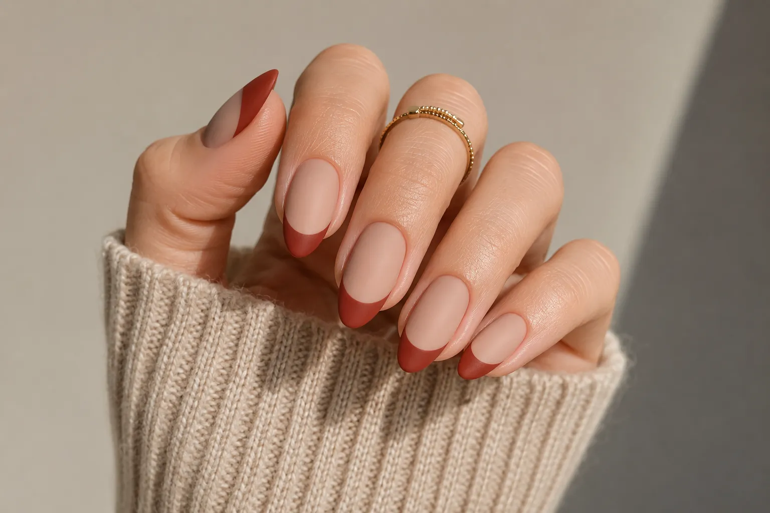 Matte brick red French tip nails with a velvet finish