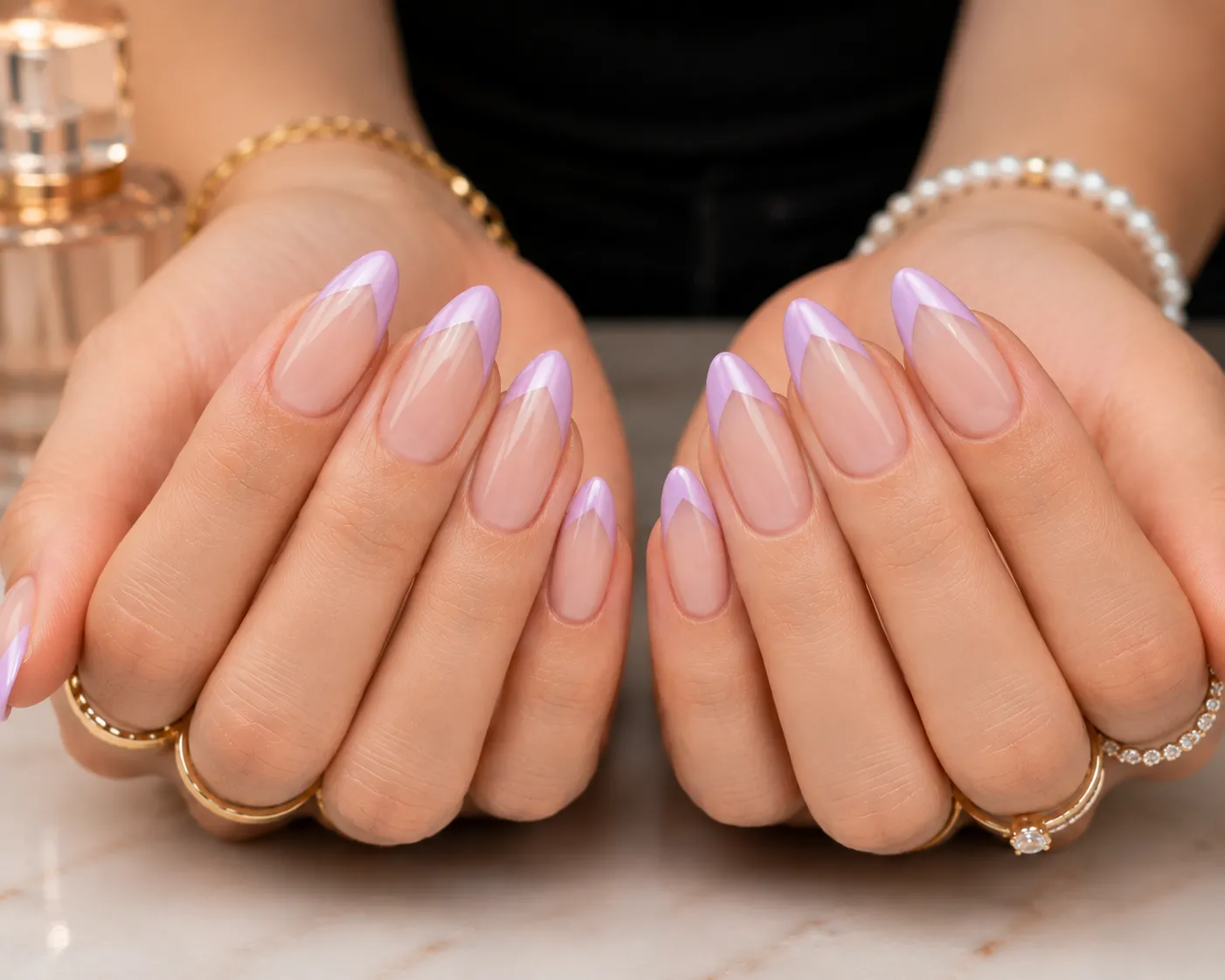 Pastel lilac V-cut French tip nails on a sheer nude base