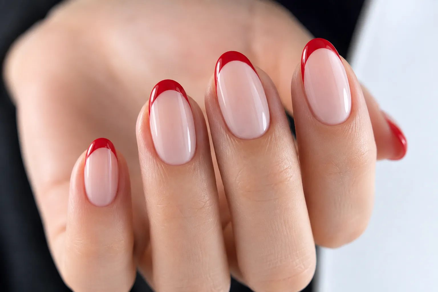 Red French tips on oval nails with a soft rounded free edge