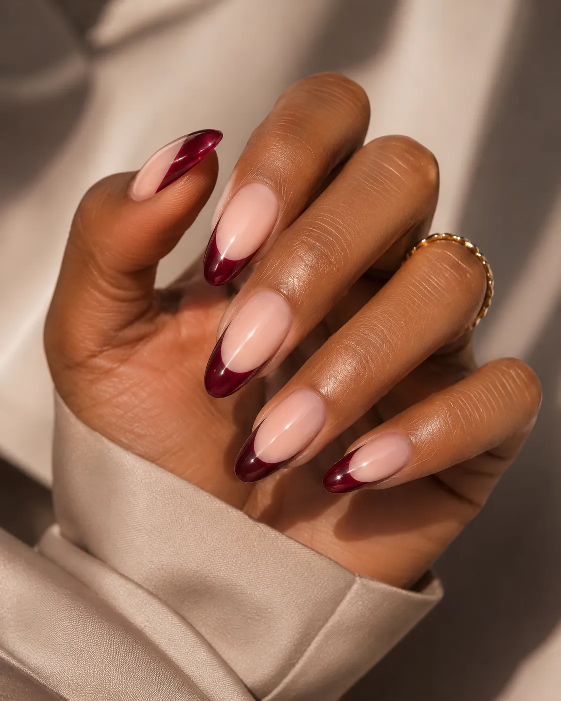 Ruby wine and oxblood French tips on deep skin