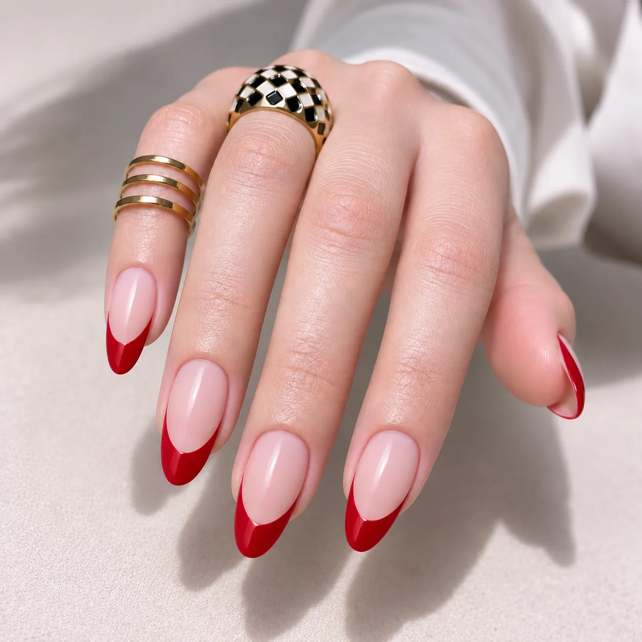 Cherry and ruby red French tips on fair cool-toned skin