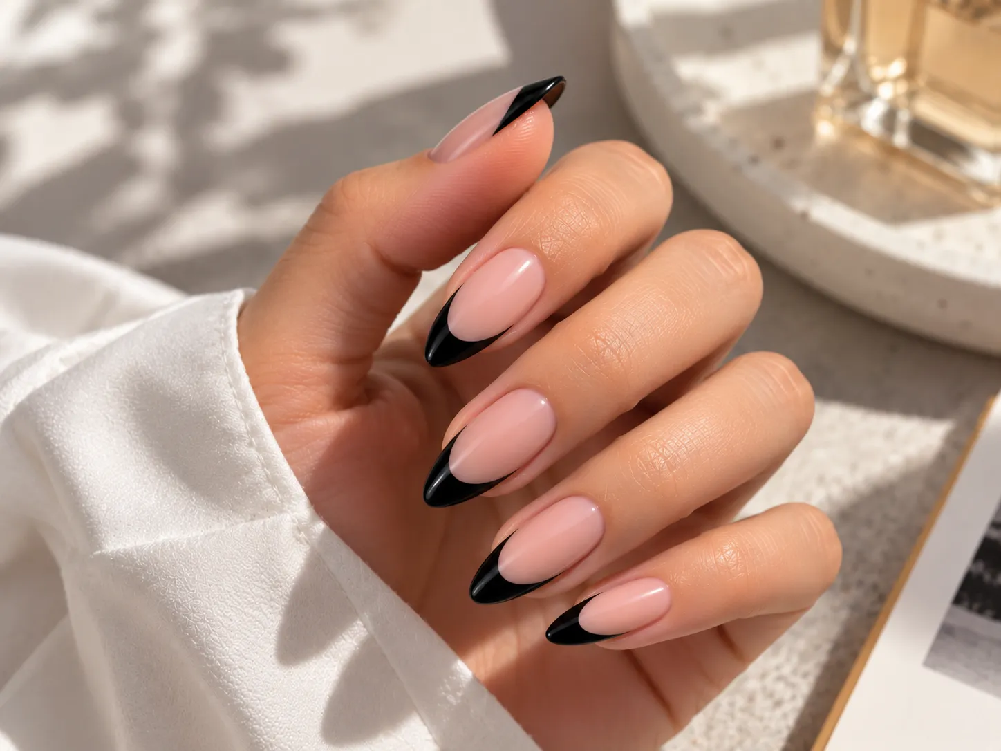 Black French tip nails on almond shaped nails