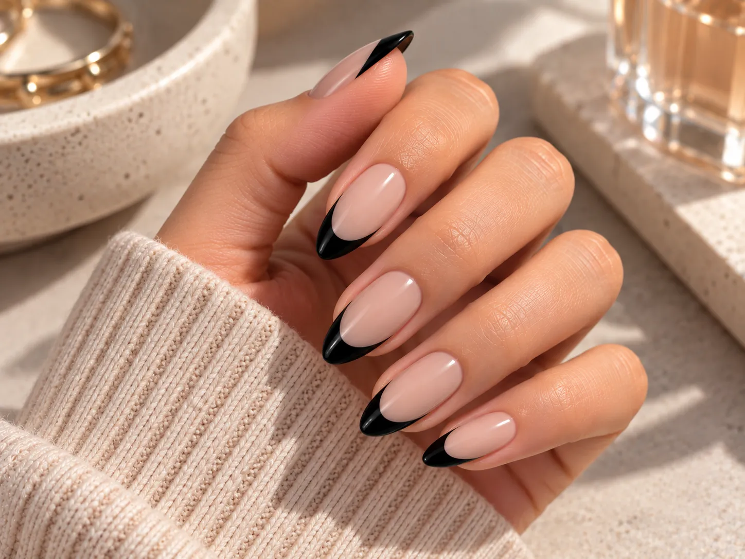 Black French tip nails with a sheer nude base