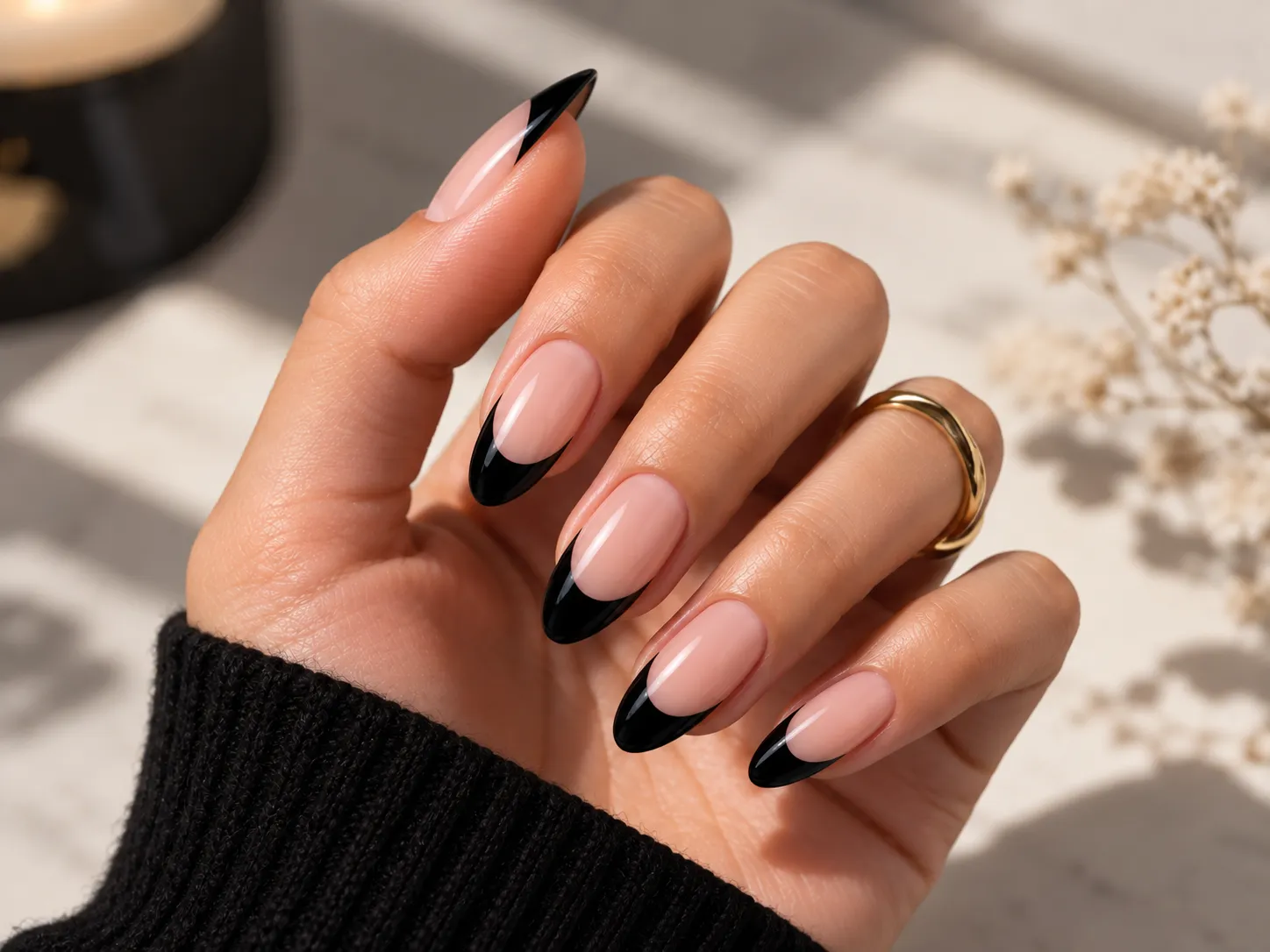 Classic black French tip nails with a sheer neutral base and clean black edges