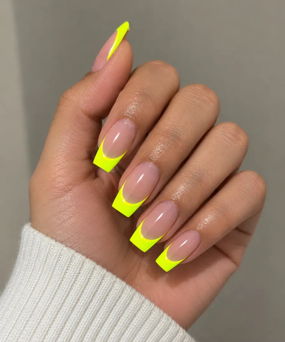 Neon yellow French tip nails with vivid fluorescent yellow smile lines
