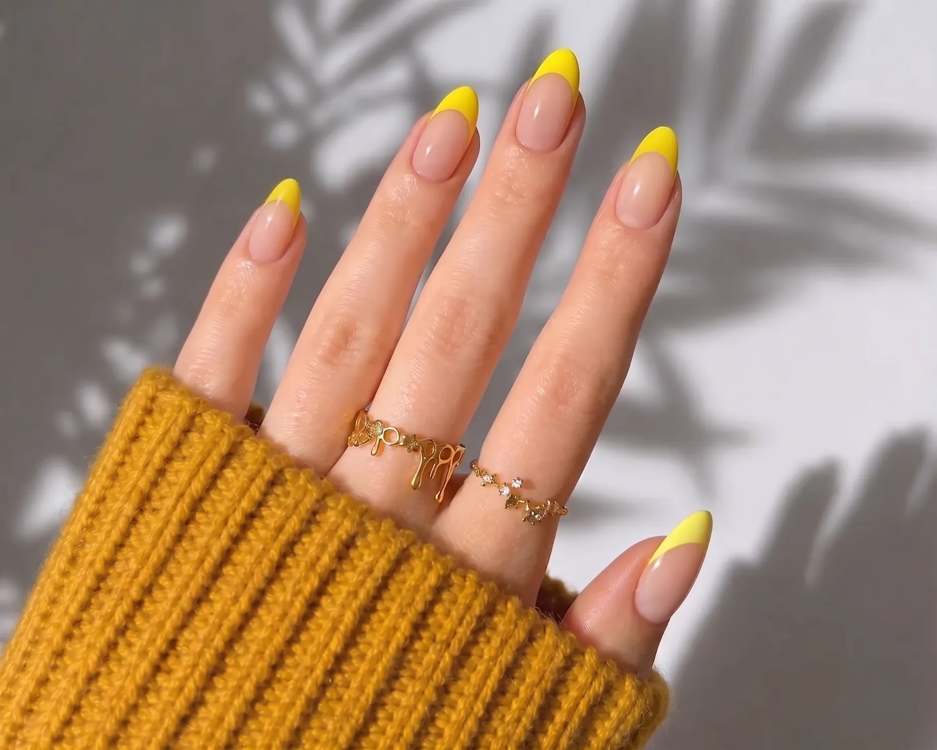 Lemon yellow French tip nails with bright yellow tips over a clean base