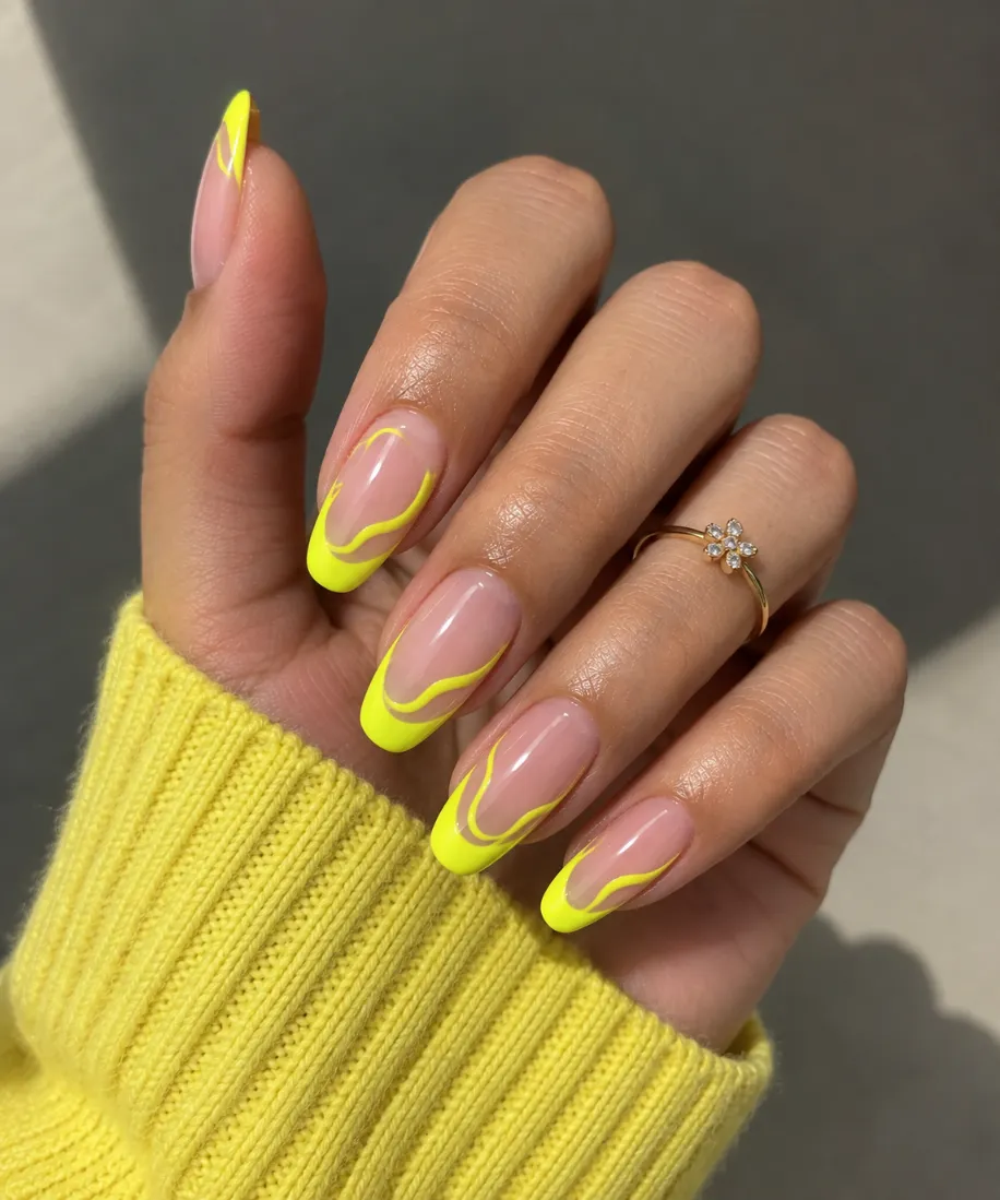 Yellow swirl French tip nails with curved yellow linework